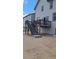 Back of house with raised deck and stairs leading down to the yard at 394 Grey Rock St, Brighton, CO 80601