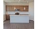 Modern kitchen featuring stainless steel appliances, a white island, and stylish pendant lighting at 394 Grey Rock St, Brighton, CO 80601