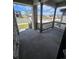 View from covered porch of neighborhood with stone supports and dark railings at 394 Grey Rock St, Brighton, CO 80601