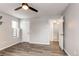 Bright bedroom features a ceiling fan, natural light from a window, and an open doorway at 14100 E Temple Dr # W01, Aurora, CO 80015