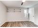 Bright bedroom features a ceiling fan, floating shelves, natural light, and wood-look flooring at 14100 E Temple Dr # W01, Aurora, CO 80015