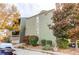 Exterior view of a multi-level condo building surrounded by colorful bushes and trees at 14100 E Temple Dr # W01, Aurora, CO 80015