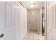 This hallway features tile flooring, multiple closets, and stainless steel appliances at 14100 E Temple Dr # W01, Aurora, CO 80015