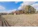 Expansive backyard surrounded by mature trees and a wooden fence, offering privacy and space at 1095 Lake Woodmoor Dr, Monument, CO 80132