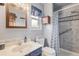 This cozy bathroom has a nice shower, toilet, sink, mirror, and tile flooring at 1095 Lake Woodmoor Dr, Monument, CO 80132