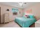 Bright bedroom featuring a ceiling fan, carpet, an art piece, and a nice window at 1095 Lake Woodmoor Dr, Monument, CO 80132
