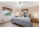 Cozy bedroom showcasing a decorative ceiling fan, ample natural light, and comfortable furnishings at 1095 Lake Woodmoor Dr, Monument, CO 80132
