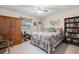 Bedroom featuring wood accents, a ceiling fan, carpet flooring, and a window with natural light at 1095 Lake Woodmoor Dr, Monument, CO 80132