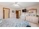 Comfortable bedroom with ceiling fan, a dresser, and a large mirror at 1095 Lake Woodmoor Dr, Monument, CO 80132
