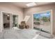 Spacious bonus room with two sliding glass doors that lead to the outdoor space at 1095 Lake Woodmoor Dr, Monument, CO 80132