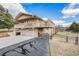 Multi-level home featuring a private deck, two-car garage, and beautiful landscaping at 1095 Lake Woodmoor Dr, Monument, CO 80132