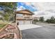 Exterior view of the home with a large deck and three-car garage at 1095 Lake Woodmoor Dr, Monument, CO 80132