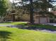Lovely two-story home with mature trees and a brick facade at 1095 Lake Woodmoor Dr, Monument, CO 80132