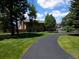 Spacious, two-story home with a long driveway and mature trees at 1095 Lake Woodmoor Dr, Monument, CO 80132