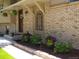 Charming brick home with flower baskets and front porch at 1095 Lake Woodmoor Dr, Monument, CO 80132