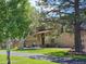 Beautiful home with brick accents, mature trees, and well-manicured lawn at 1095 Lake Woodmoor Dr, Monument, CO 80132