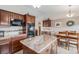 Spacious kitchen featuring dark wood cabinets, granite countertops, and modern appliances at 1095 Lake Woodmoor Dr, Monument, CO 80132