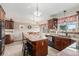 Bright eat-in kitchen featuring island with stool seating and a view at 1095 Lake Woodmoor Dr, Monument, CO 80132