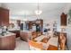 Open concept kitchen with rich wood cabinetry, granite countertops, and stainless steel appliances at 1095 Lake Woodmoor Dr, Monument, CO 80132