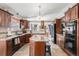 Well-equipped kitchen featuring granite countertops, stainless steel appliances, and custom cabinetry at 1095 Lake Woodmoor Dr, Monument, CO 80132
