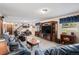 Spacious basement living room with a large TV, carpet flooring, and leather furniture at 1095 Lake Woodmoor Dr, Monument, CO 80132