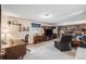 Comfortable living room with a brick fireplace, desk, and built-in media center at 1095 Lake Woodmoor Dr, Monument, CO 80132