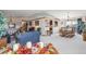 Spacious living area with a comfortable blue sofa, fireplace, and open access to the dining room at 1095 Lake Woodmoor Dr, Monument, CO 80132