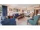 Comfortable living room featuring a staircase, plush seating, and ample natural light from the large window at 1095 Lake Woodmoor Dr, Monument, CO 80132