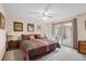Carpeted main bedroom with a ceiling fan, and sliding glass door leading to the outdoor space at 1095 Lake Woodmoor Dr, Monument, CO 80132