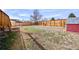 Fenced backyard with grass, a storage shed, and mature trees at 1640 Amherst Dr, Longmont, CO 80503