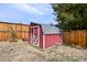 Red storage shed in fenced backyard at 1640 Amherst Dr, Longmont, CO 80503