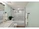 Basement bathroom with marble-look shower and light green walls at 2845 N Vine St, Denver, CO 80205