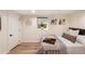 Basement bedroom with a queen bed, neutral decor, and a window at 2845 N Vine St, Denver, CO 80205