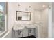 Updated bathroom with double sinks, subway tile and a glass shower at 2845 N Vine St, Denver, CO 80205