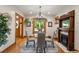 Bright dining room with hardwood floors, a glass table, and a fireplace at 2845 N Vine St, Denver, CO 80205