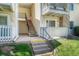 Ground-level view of a condo entrance featuring stairs and a small outdoor area at 8555 Fairmount Dr # G103, Denver, CO 80247