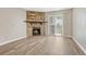 Cozy living room with stone fireplace and sliding door leading to outdoor space at 8555 Fairmount Dr # G103, Denver, CO 80247