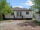 Back of the house showcasing the deck and fenced yard, detached garage, gravel driveway at 449 King St, Denver, CO 80204
