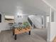 Basement features game table, chairs, stairs to main floor, and modern decor at 449 King St, Denver, CO 80204