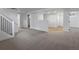 Open basement featuring neutral carpet, white support columns, and a view into an adjacent room at 449 King St, Denver, CO 80204