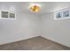 Bright basement room featuring neutral carpet, a unique light fixture, and natural light from two windows at 449 King St, Denver, CO 80204