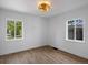 Bedroom featuring new flooring, modern ceiling fan and dual windows at 449 King St, Denver, CO 80204