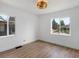 Bright bedroom featuring wood flooring, two windows providing natural light at 449 King St, Denver, CO 80204