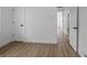 Bright bedroom featuring wood-look floors and white walls that provide a serene, modern aesthetic at 449 King St, Denver, CO 80204