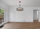 Dining room featuring wood flooring, modern chandelier, and doors to the exterior at 449 King St, Denver, CO 80204