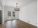 Dining room featuring wood flooring, modern chandelier, and doors to the exterior at 449 King St, Denver, CO 80204