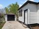 Detached garage matching the home's siding, contrasting trim, and adjacent backyard at 449 King St, Denver, CO 80204