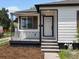 Close up of the freshly painted front exterior featuring a small porch and steps leading to the front door at 449 King St, Denver, CO 80204
