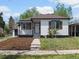 Charming home with a well-manicured lawn, fresh mulch, and sidewalk leading up to the front door at 449 King St, Denver, CO 80204