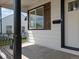 Cozy front porch featuring a view of the yard and neighborhood, plus a mailbox and dark shutters at 449 King St, Denver, CO 80204